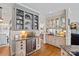 Open butler pantry with granite countertops, glass display cabinets, and a beverage fridge at 10500 Kilmory Ter, Charlotte, NC 28210