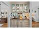 Butler's pantry featuring granite countertops, custom cabinets, and mirrored backsplash at 10500 Kilmory Ter, Charlotte, NC 28210