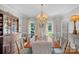 Formal dining room with classic chandelier, large windows, and elegant details for gatherings and dinner parties at 10500 Kilmory Ter, Charlotte, NC 28210