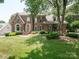 Charming two-story brick home with manicured lawn and mature trees at 10500 Kilmory Ter, Charlotte, NC 28210