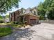 Side view of the brick house showing the garage and ample parking space at 10500 Kilmory Ter, Charlotte, NC 28210
