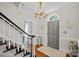 Inviting foyer featuring hardwood floors, elegant lighting, and staircase at 10500 Kilmory Ter, Charlotte, NC 28210