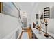 Elegant foyer featuring hardwood floors, staircase, chandelier, and decorative console table with lamps at 10500 Kilmory Ter, Charlotte, NC 28210