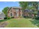 Beautiful brick home with a manicured lawn and mature trees in a desirable neighborhood at 10500 Kilmory Ter, Charlotte, NC 28210