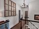 Hallway boasts wainscoting, chandelier, and decorative window panel at 10500 Kilmory Ter, Charlotte, NC 28210