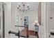 Upstairs hallway featuring hardwood floors, chandelier, and views of other rooms at 10500 Kilmory Ter, Charlotte, NC 28210