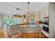 Spacious kitchen featuring custom cabinets, butcher block island, granite countertops, and natural light from many windows at 10500 Kilmory Ter, Charlotte, NC 28210