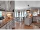 Well-appointed kitchen flows into the dining area, featuring custom cabinets and modern lighting fixtures at 10500 Kilmory Ter, Charlotte, NC 28210