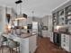 Spacious kitchen features stainless steel appliances, granite countertops, and a large island with bar seating at 10500 Kilmory Ter, Charlotte, NC 28210
