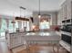 Updated kitchen with a central island, custom cabinetry, and views into the adjacent dining area at 10500 Kilmory Ter, Charlotte, NC 28210