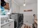 Modern laundry room with stainless steel appliances, sink, and ample cabinet space at 10500 Kilmory Ter, Charlotte, NC 28210