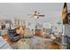 Large living room features hardwood floors, ceiling fan, and comfortable seating options throughout the open concept space at 10500 Kilmory Ter, Charlotte, NC 28210