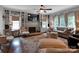 Bright living room featuring a fireplace, built-in bookshelves, and large windows with elegant curtains at 10500 Kilmory Ter, Charlotte, NC 28210