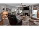 Comfortable living room with a fireplace, built-ins, and views into other rooms of the home at 10500 Kilmory Ter, Charlotte, NC 28210