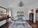 Comfortable living room with hardwood floors, chandelier, and traditional decor at 10500 Kilmory Ter, Charlotte, NC 28210