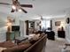 Cozy living room with a comfortable brown sofa, wooden furniture, and a ceiling fan for added comfort at 10500 Kilmory Ter, Charlotte, NC 28210