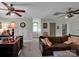 Bright living area with large brown sofa, light green walls, and carpet, featuring wooden furniture and neutral color decor at 10500 Kilmory Ter, Charlotte, NC 28210