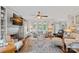 Comfortable living room with fireplace, built-in shelves, ceiling fan, and large windows offering bright light at 10500 Kilmory Ter, Charlotte, NC 28210