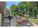 Outdoor patio with seating, grill, lighting, and green landscaping at 10500 Kilmory Ter, Charlotte, NC 28210