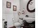 Charming powder room with decorative mirror and elegant wall accents at 10500 Kilmory Ter, Charlotte, NC 28210