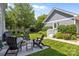 Backyard patio with outdoor seating, perfect for entertaining, surrounded by lush landscaping at 15628 Waterfront Dr, Huntersville, NC 28078