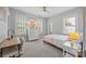 Light-filled bedroom with neutral walls, dresser, desk, and ample natural light from shuttered windows at 15628 Waterfront Dr, Huntersville, NC 28078