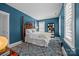 Cozy bedroom features a four-poster bed, blue walls, and natural light from large windows at 15628 Waterfront Dr, Huntersville, NC 28078
