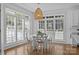 Charming breakfast nook with bright natural light, a modern light fixture, and white table and chairs at 15628 Waterfront Dr, Huntersville, NC 28078
