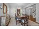 Spacious dining room with modern chandelier, wooden table, and many windows with lots of natural light at 15628 Waterfront Dr, Huntersville, NC 28078