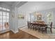 Elegant dining room with a chandelier, large windows, and neutral color palette at 15628 Waterfront Dr, Huntersville, NC 28078