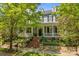 Charming two-story home featuring a welcoming front porch and beautifully landscaped front yard at 15628 Waterfront Dr, Huntersville, NC 28078