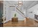 Bright entryway featuring hardwood floors, a staircase, and elegant lighting at 15628 Waterfront Dr, Huntersville, NC 28078