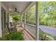 Relaxing front porch with ceiling fan and rocking chairs overlooking a peaceful street at 15628 Waterfront Dr, Huntersville, NC 28078
