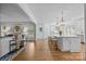 Open-concept kitchen with a large island, counter seating, and seamless flow to the living area at 15628 Waterfront Dr, Huntersville, NC 28078