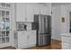 Kitchen area featuring stainless steel refrigerator, white cabinets, and a coffee station at 15628 Waterfront Dr, Huntersville, NC 28078