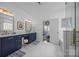 Elegant bathroom featuring dual sink vanity with navy cabinets and luxurious walk-in shower at 15628 Waterfront Dr, Huntersville, NC 28078