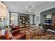 Stylish office with dark green walls, custom rug, bookshelves, and comfortable leather chairs at 15628 Waterfront Dr, Huntersville, NC 28078