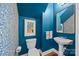 Charming powder room with bold blue wallpaper, pedestal sink, and classic fixtures at 15628 Waterfront Dr, Huntersville, NC 28078