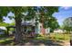 Charming two-story home featuring a covered porch, a brick chimney, and a well-maintained lawn at 164 N Eastway Dr, Troutman, NC 28166