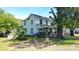 Two-story home with a covered front porch, a fenced yard, and mature landscaping at 164 N Eastway Dr, Troutman, NC 28166