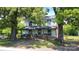 Charming two-story home featuring a covered front porch with inviting seating and mature trees at 164 N Eastway Dr, Troutman, NC 28166