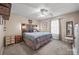 Cozy bedroom featuring soft carpet, a ceiling fan, and a decorative wooden headboard at 1668 Tate Rd, Rock Hill, SC 29732