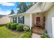 Close-up of a home's welcoming porch with a red door and decorated seating area at 1668 Tate Rd, Rock Hill, SC 29732