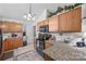 Bright kitchen features granite countertops, stylish lighting and wooden cabinetry at 1668 Tate Rd, Rock Hill, SC 29732