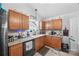 A well-lit kitchen boasts granite countertops, stainless appliances, and wooden cabinetry at 1668 Tate Rd, Rock Hill, SC 29732