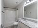 Bright bathroom with white vanity, granite countertop, and a shower-tub combination at 1782 Oakdale Rd, Rock Hill, SC 29730