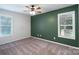 Bedroom featuring neutral carpet, two windows and an accent wall at 1782 Oakdale Rd, Rock Hill, SC 29730