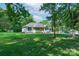 Serene home exterior surrounded by mature trees and a well-maintained lawn at 1782 Oakdale Rd, Rock Hill, SC 29730
