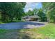 Spacious home with an expansive driveway and carport, nestled amidst lush greenery at 1782 Oakdale Rd, Rock Hill, SC 29730