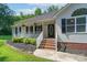 Inviting front porch with white railings and brick steps, complemented by manicured landscaping at 1782 Oakdale Rd, Rock Hill, SC 29730
